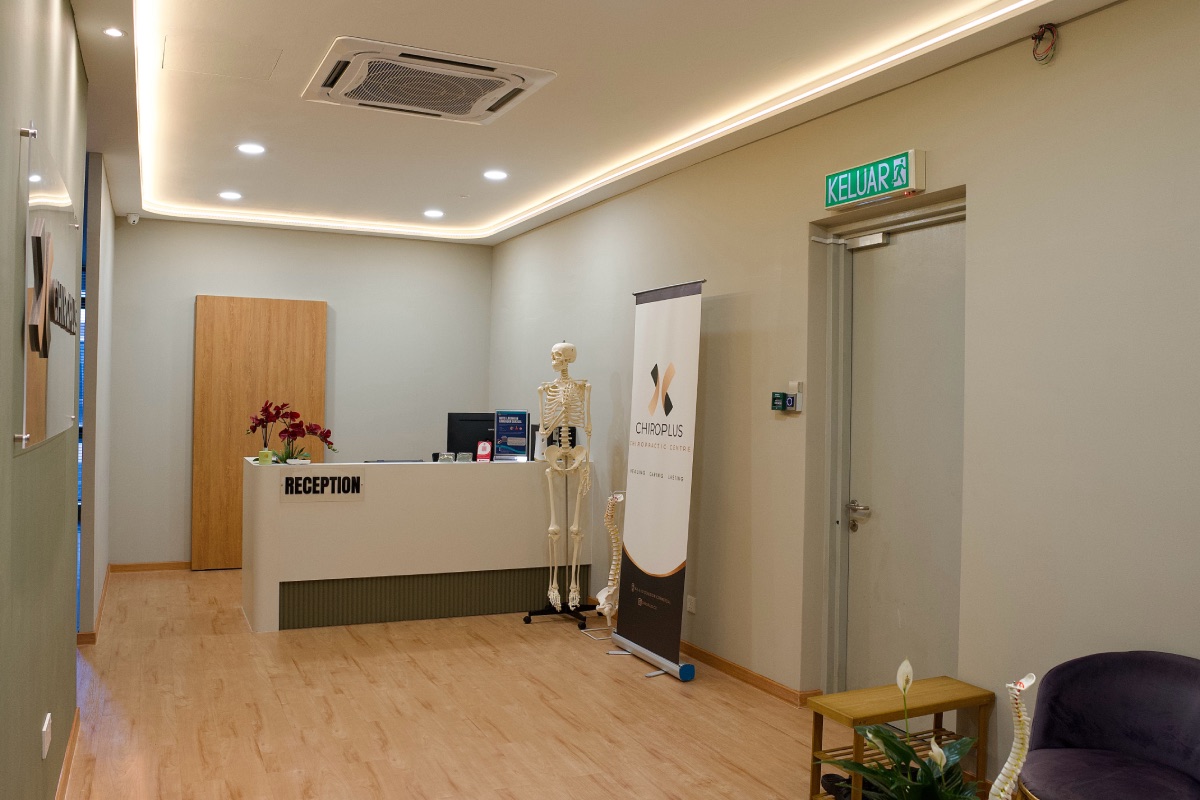 ChiroPlus reception lobby with branding banner